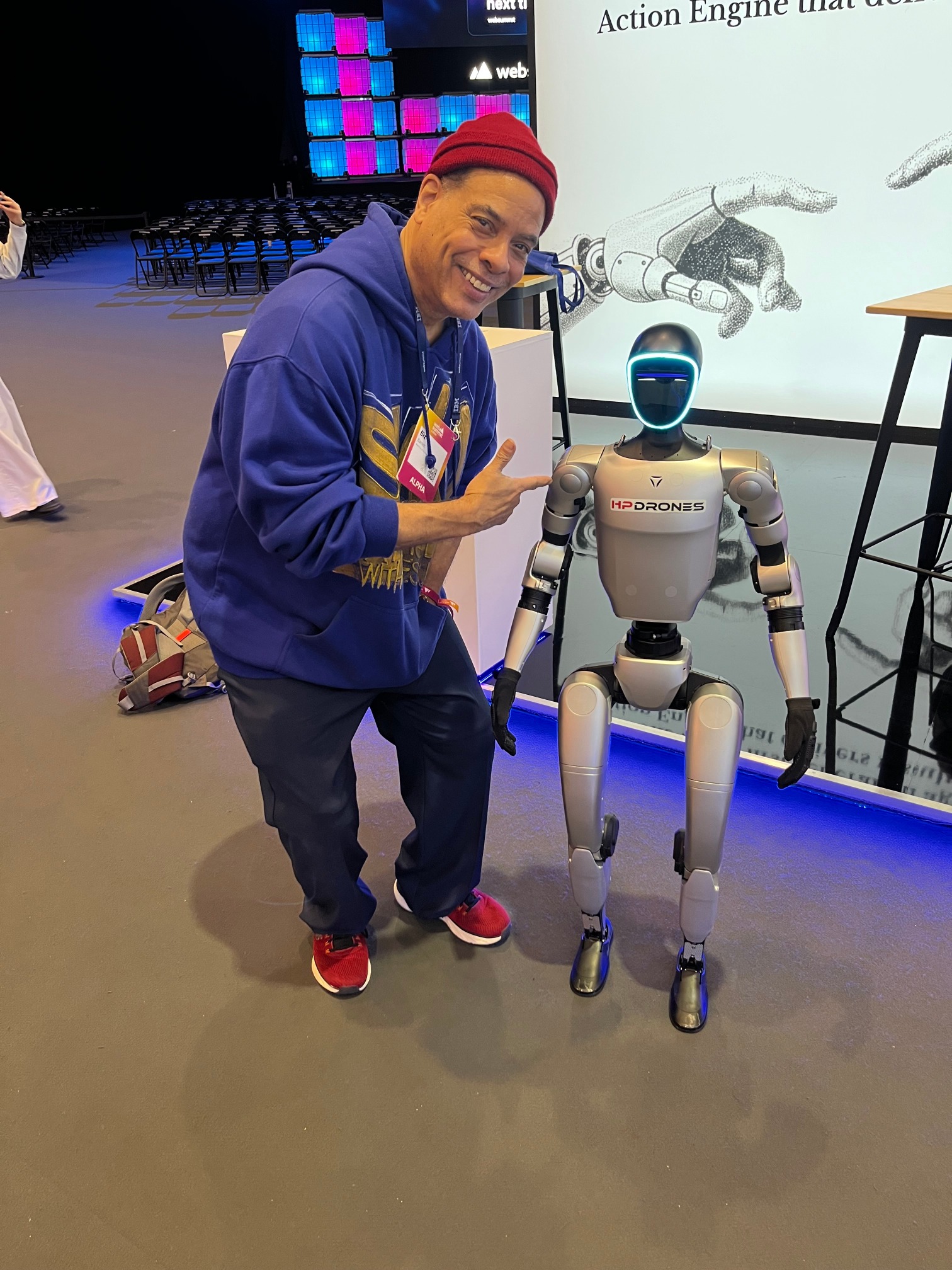 Biz Barrett smiling beside a robot