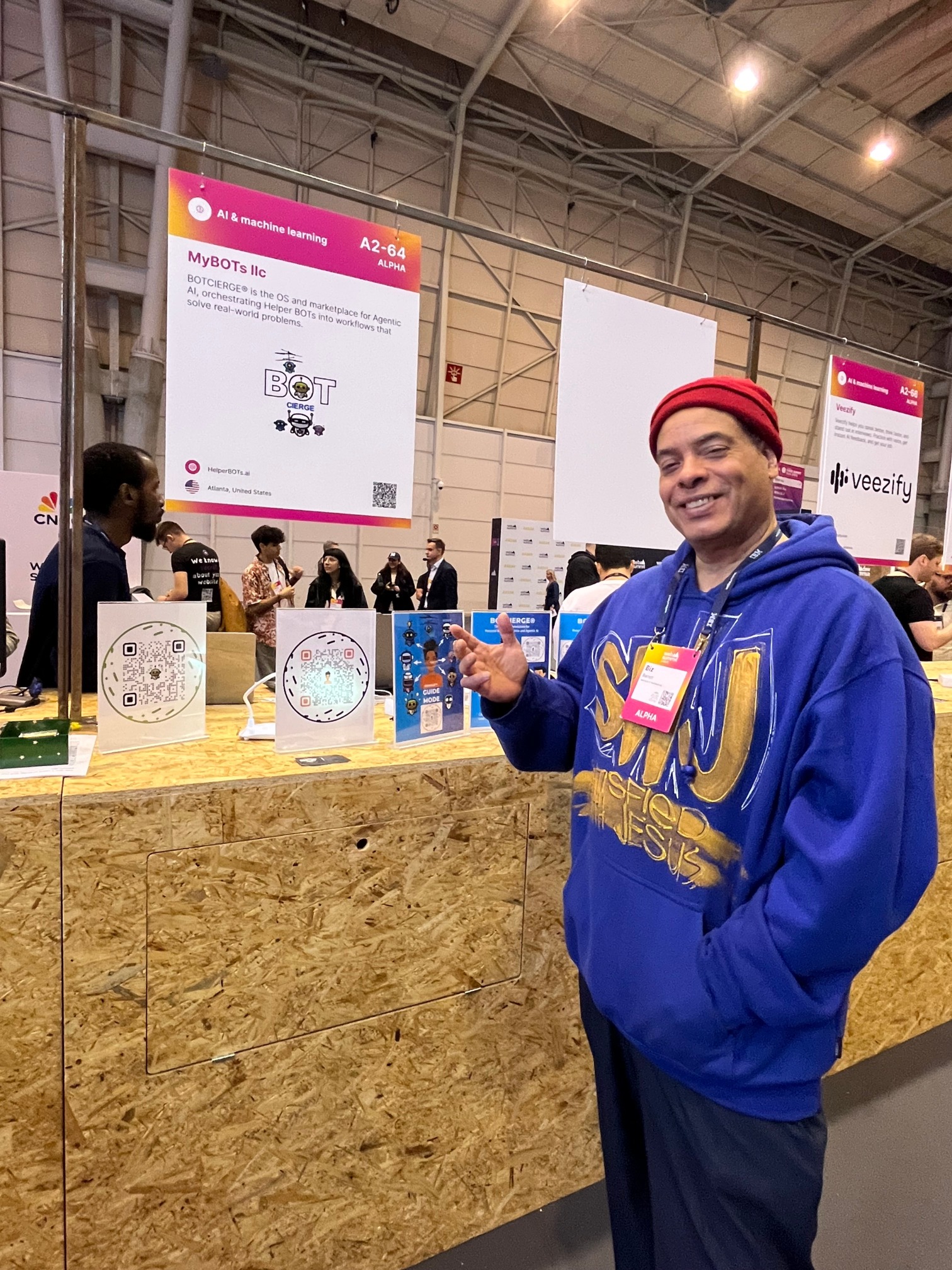 Biz Barrett standing at the BOTCIERGE booth table
