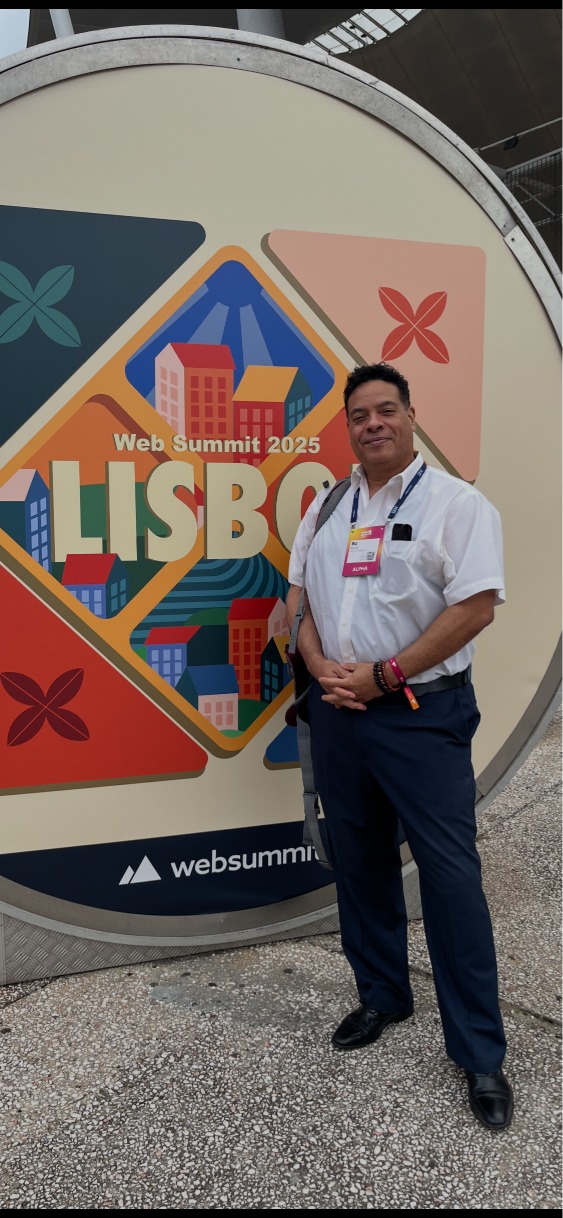 Biz Barrett standing in front of the Web Summit Lisbon logo