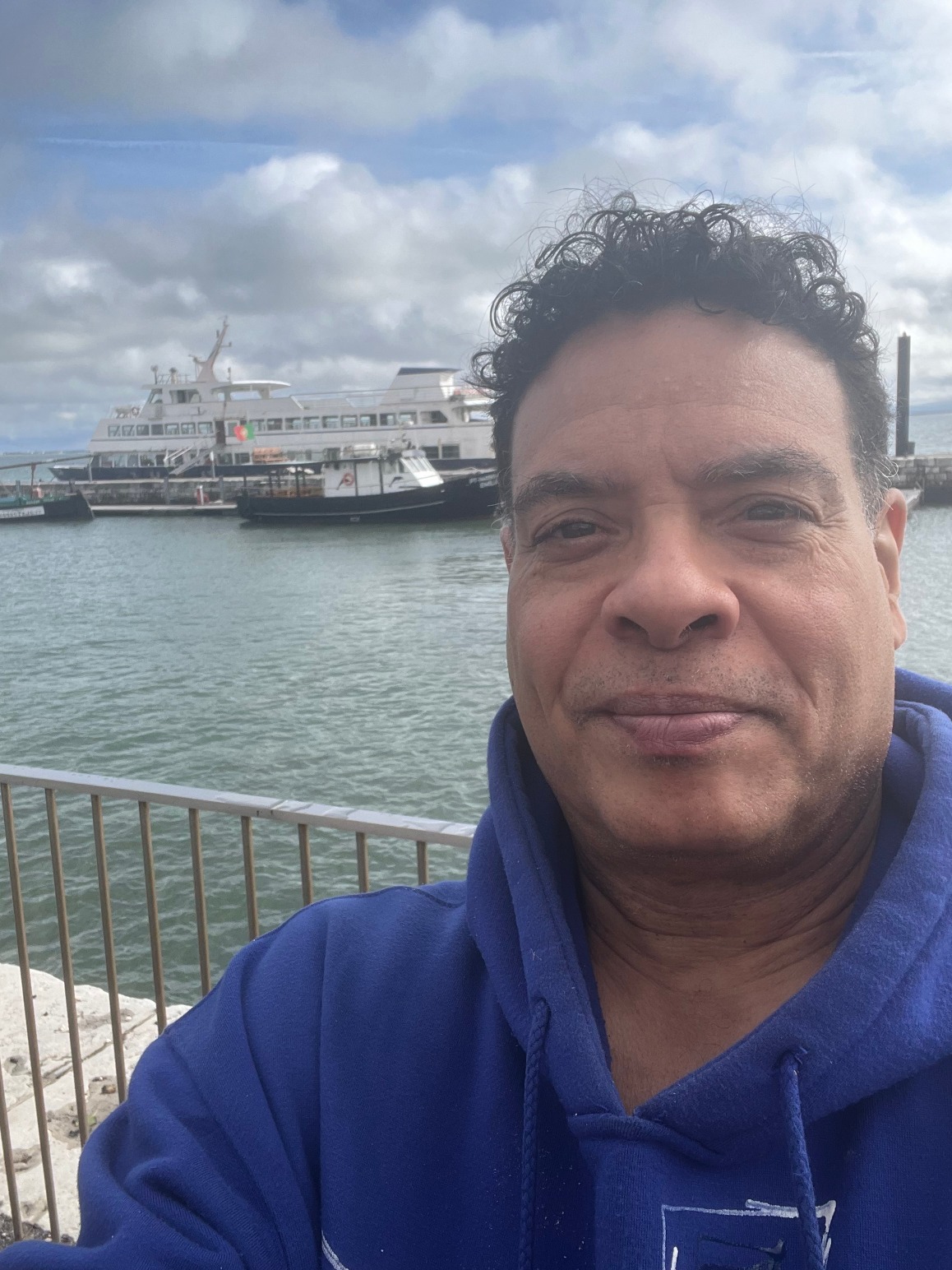 Close up of Biz Barrett at Lisbon harbor with boats in the background